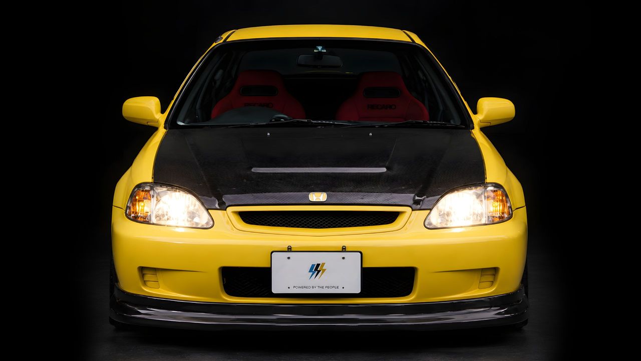 A yellow EK Civic fitted with a DOOBIE carbon bonnet, photographed head-on